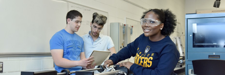 Three students working in an engineering lab