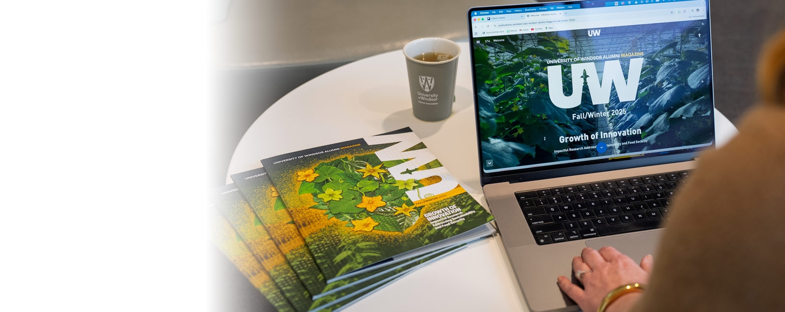 Person reading digital version of the Alumni Magazine on laptop