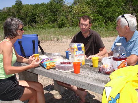 Marie-Jeanne Monette, François Georges and Alan Wright sitting at picnic table.