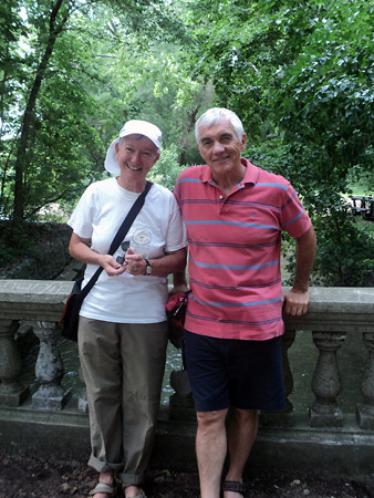 Patsy Paxton and Alan Wright pose on a bridge in front of ornate stone rails.
