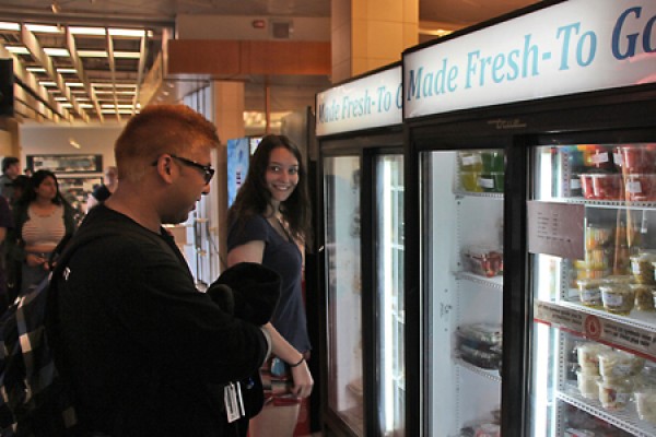 Students Shane Gonsalves and Rachel Pieniazek look into coolers.