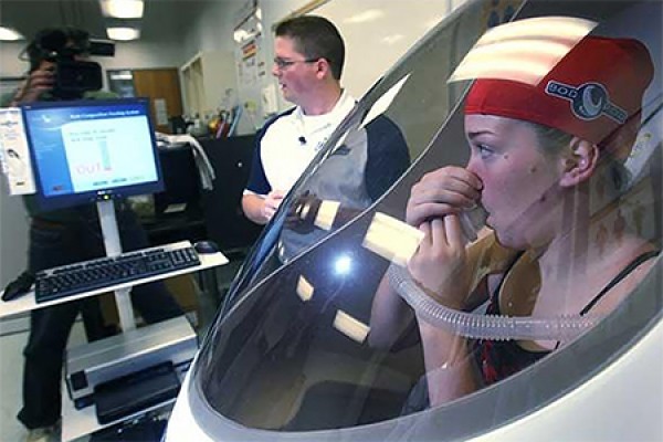 Chad Sutherland puts Milana McNamee through a body density test in the Bod Pod. 