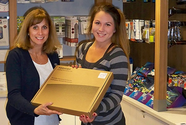 Campus Bookstore manager Cathy Ladouceur congratulates prize winner Chevonne Hardcastle.