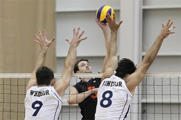 Shawn Reaume and Alexander Vukovic of the Lancer men’s volleyball squad jump to block a shot.