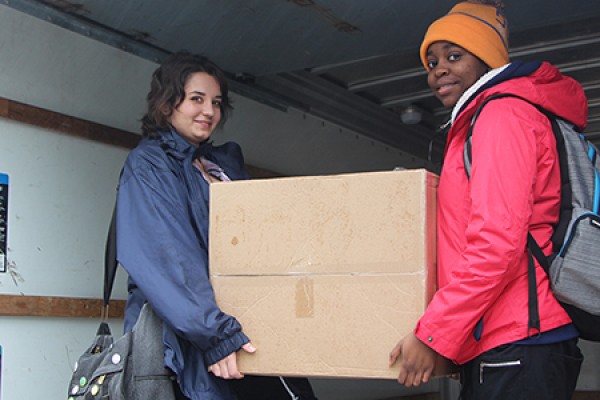 Vicky Papuga and Krysta Sutton load a box full of gifts