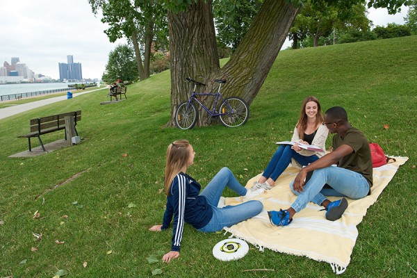 students sitting on lawn