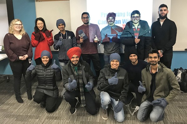 Nursing students Shae Driedger and Mohamad Bassam flank 10 international students who attended a session on how to prepare for a Canadian winter.