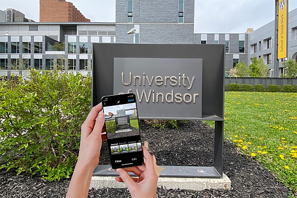 phone taking photo of sign for University of Windsor