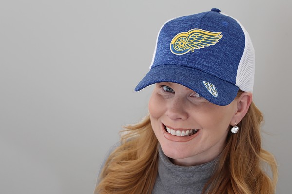Marnie Robillard wearing blue and gold Red Wings cap