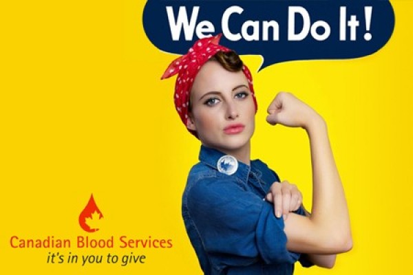 woman rolling up sleeves in Rosie the Riveter tribute
