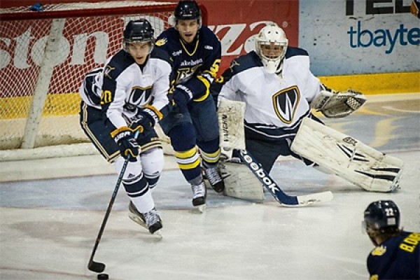 Defender Chad Shepley steers the puck away from Thunderwolves in front of Windsor’s net.