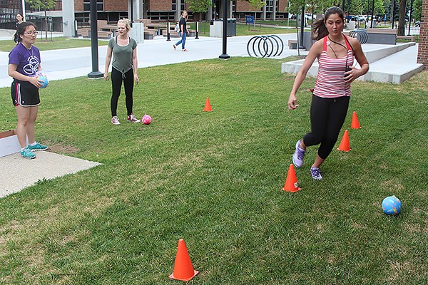 High schooler Shannon Fehr manoeuvres a ball through pylons during an event in the Amazing Science Race.