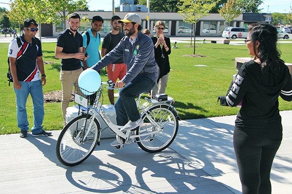 UWSA president Moussa Hamadani tries out a Zagster bike.