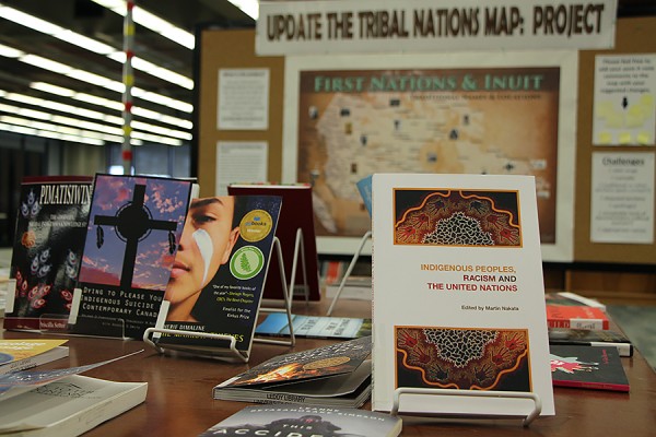 display of books with Tribal Nations map in background