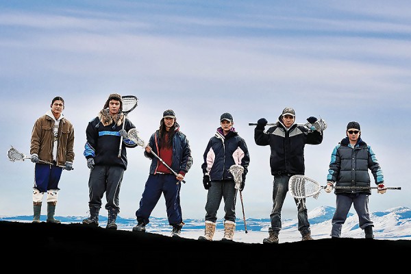 Lacrosse players standing against snowy background