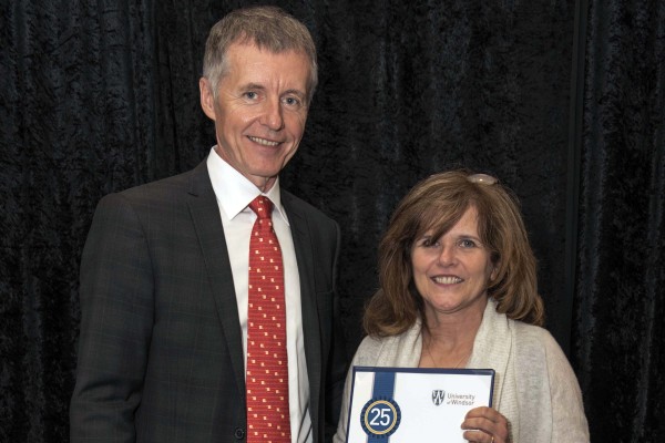 Jackie Imeson, who reached 25 years of service in 2015, accepted congratulations from UWindsor president Alan Wildeman during a luncheon on June 12.