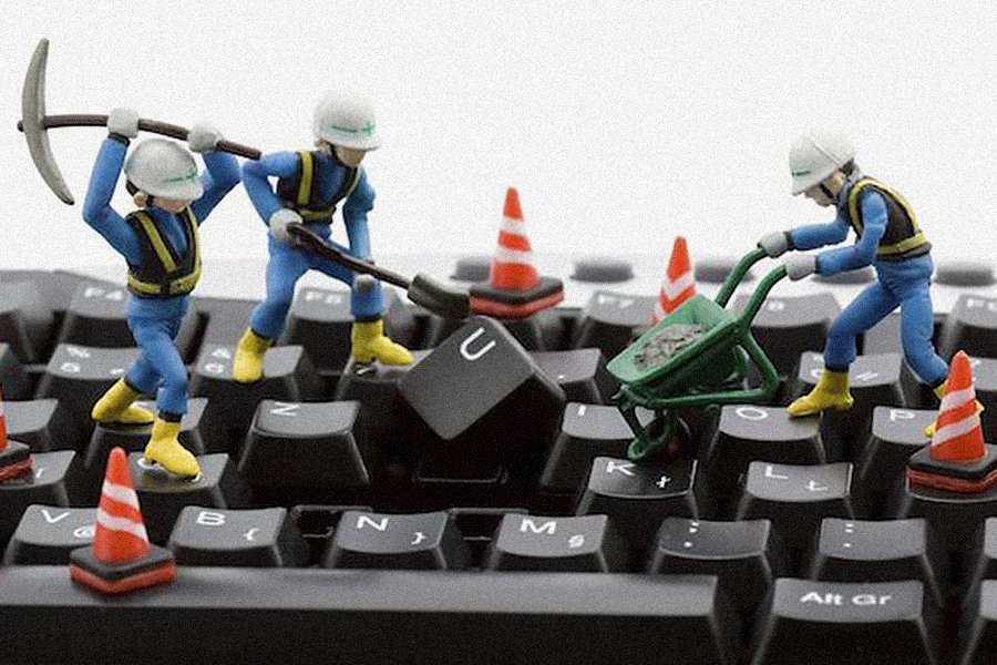 toy workers digging up keyboard