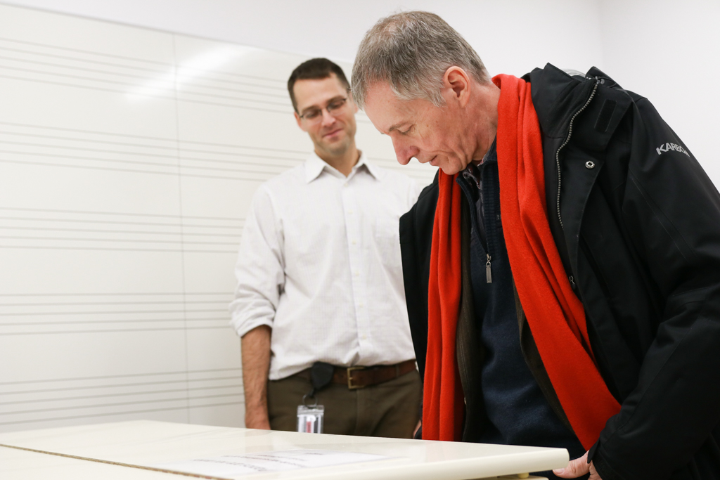 Trevor Pittman, SoCA's operations manager, watches as Dr. Alan Wildeman plays the piano in a new practice room at the Windsor Armouries.