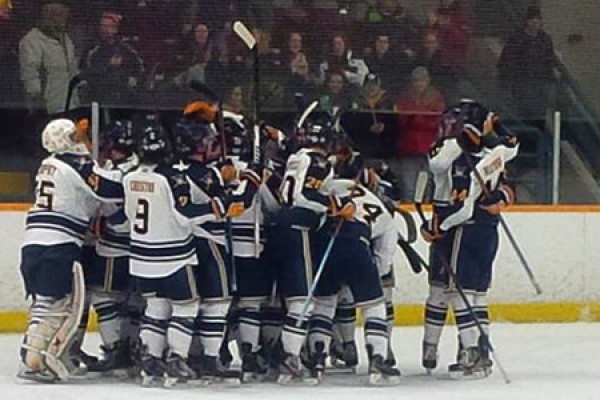 The Lancer men’s hockey team celebrates an OT win Sunday to advance in the OUA playoffs.