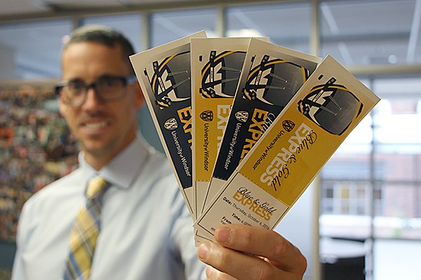 Ryan Flannagan holds tickets for the Blue and Gold Express