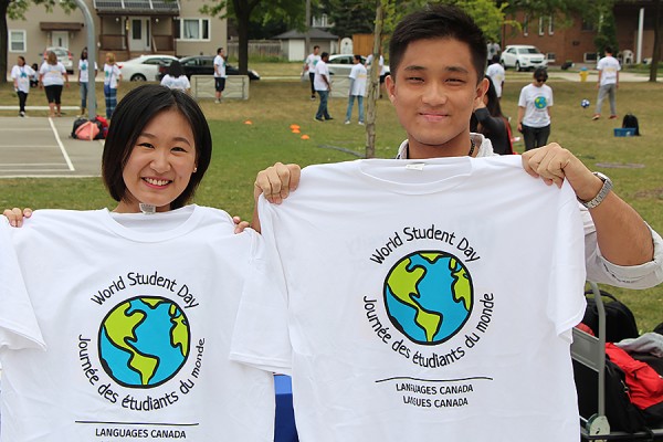 Students holding up World Student Day T-shirts