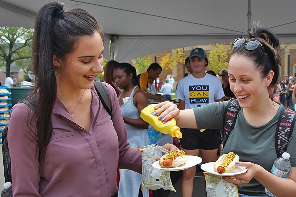 Allison Maitre and Larissa Howlett dress their hot dogs