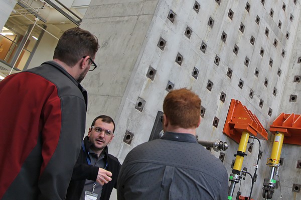 Brian Aldington and Matthew Saby of die set manufacturer Anchor Danly enjoy a tour by grad student John Magliaro of the structural engineering testing lab, Friday in the Centre for Engineering Innovation.
