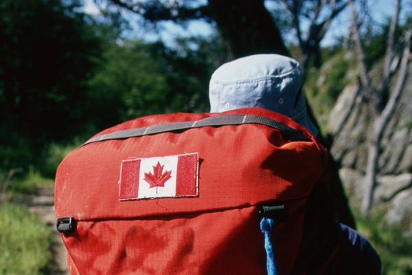 traveller with backpack sporting Canada flag patch