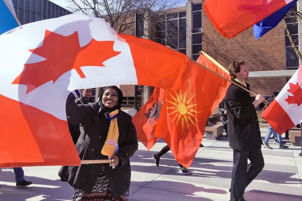 People marching with flags of many nations