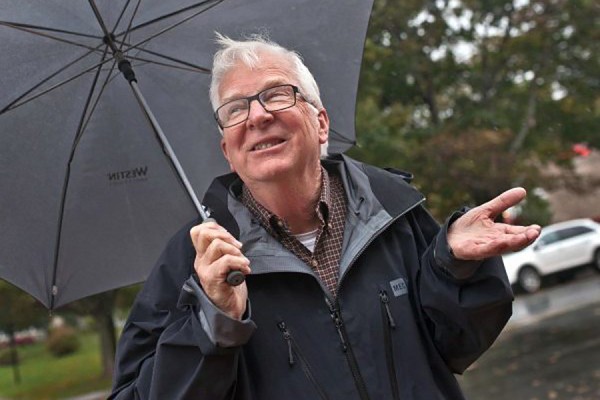Climatologist David Phillips holding umbrella