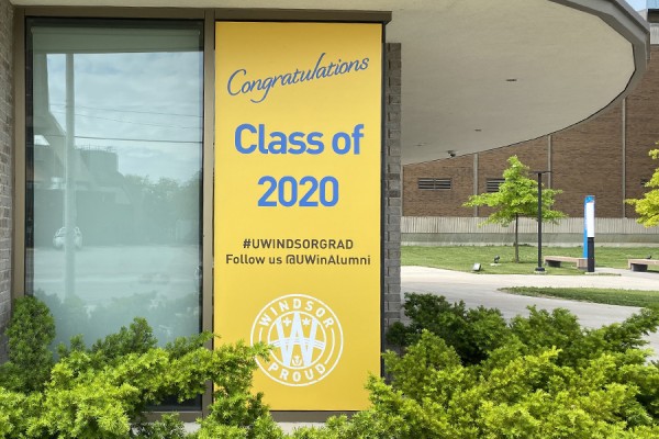 decal reading “Congratulations Graduates” placed in window