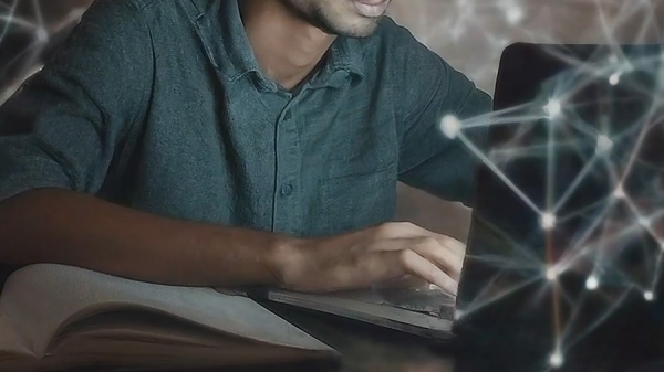 student sitting at laptop computer