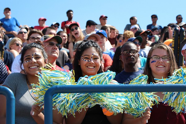 fans waving pompons in stands of south campus stadium