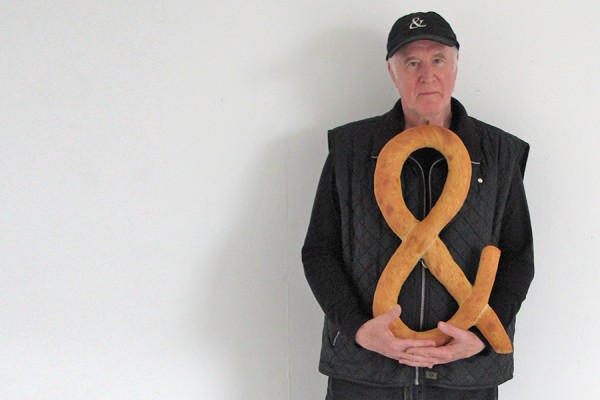Iain Baxter&amp; holding loaf of bread shaped as ampersand