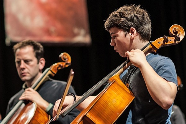 student and professional cellists perform side by side