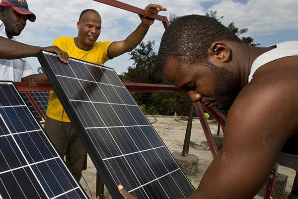 men installing solar panels