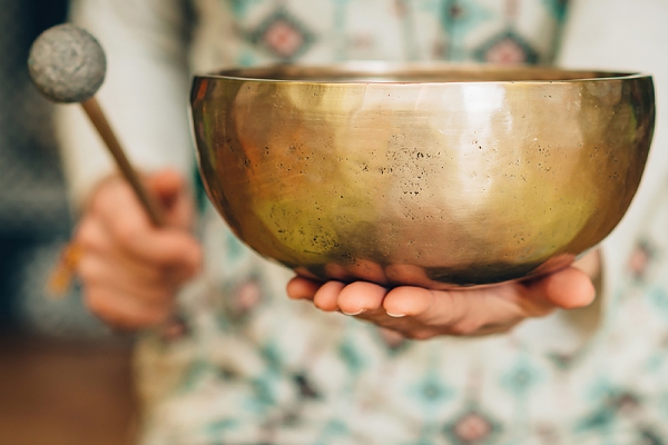 metal bowl strummed with wooden paddle