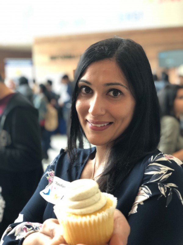 Selena Chauhan, Employment Readiness Program Facilitator, shares a cupcake