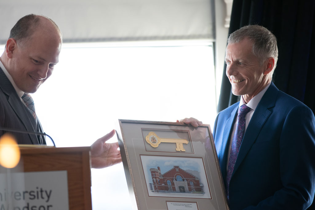 Windsor Mayor Drew Dilkens presents University of Windsor President Alan Wildeman with a key to the city during the president's farewell dinner on Tuesday, May 8, 2018.
