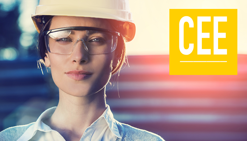Female engineer wearing safety goggles and hat.