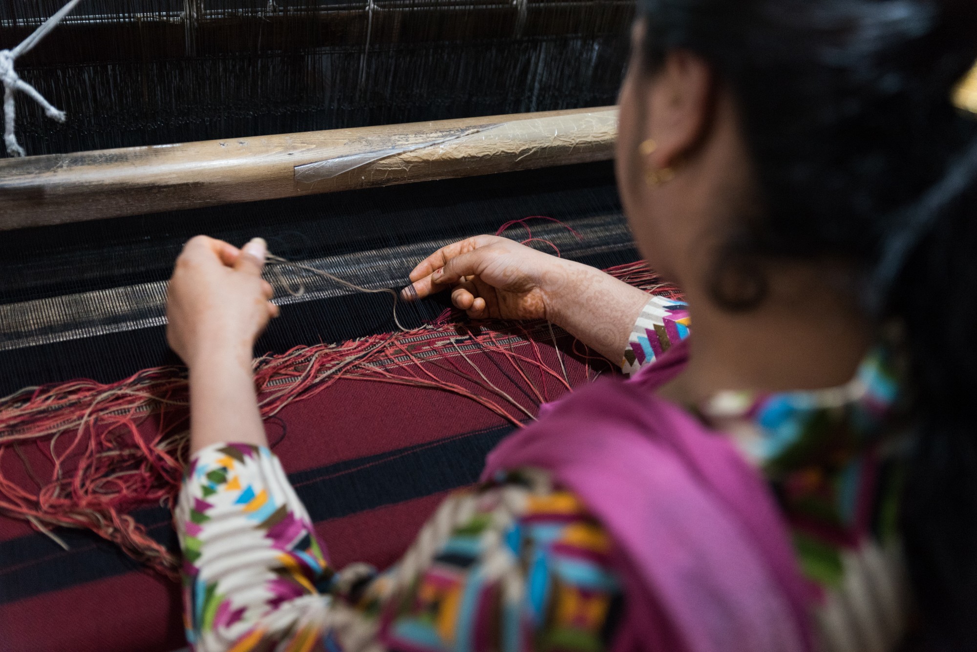 Female worker making cloth.