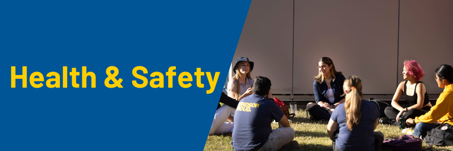 Health and Safety banner with students sitting in a group on campus