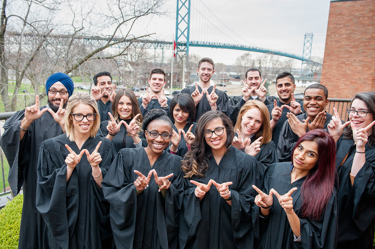 Group of students on campus in graduate gowns
