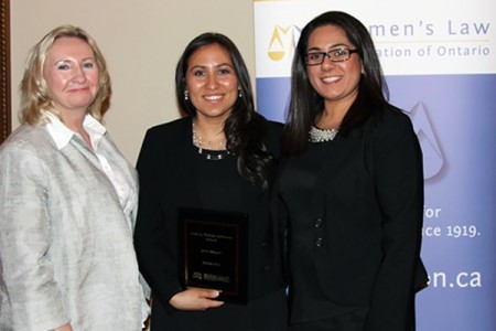 Sponsor Avril Farlam presents an award for clinic advocacy to Windsor Law graduand Emilia Coto, as Preet Singh, her supervisor at Legal Assistance of Windsor, looks on.