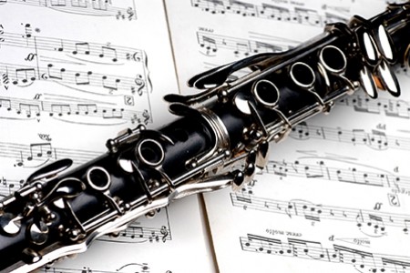 Clarinet laying on top of musical score