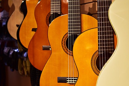 An array of hung acoustic guitars