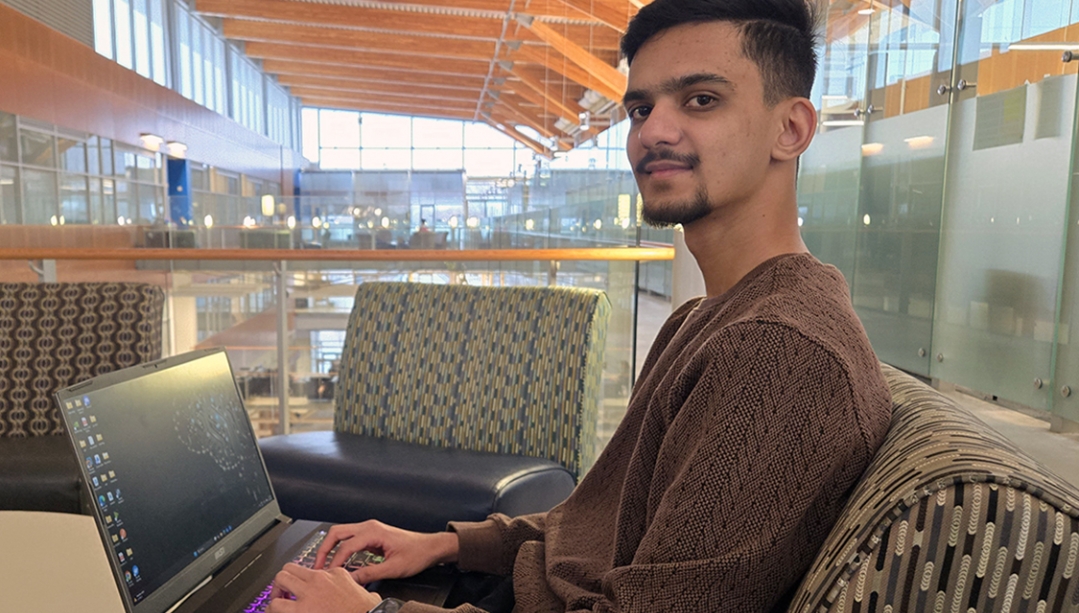 image of Vansh Patel seated with laptop
