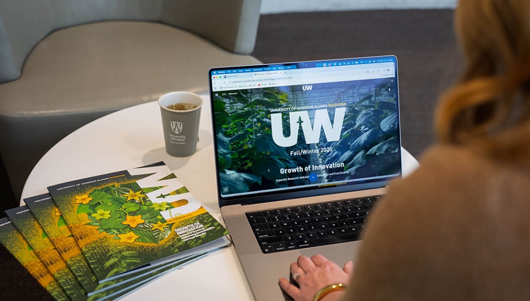 Digital edition of Alumni Magazine on a laptop.