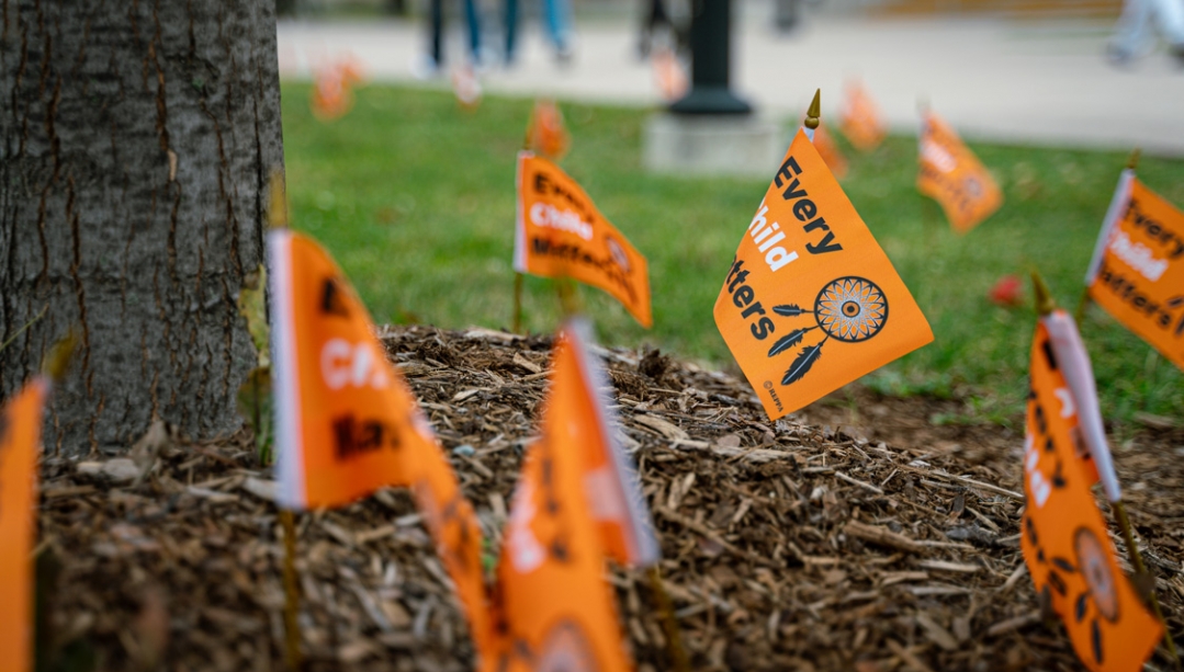 Closeup of Every Child Matters flags planted along Turtle Island Walk