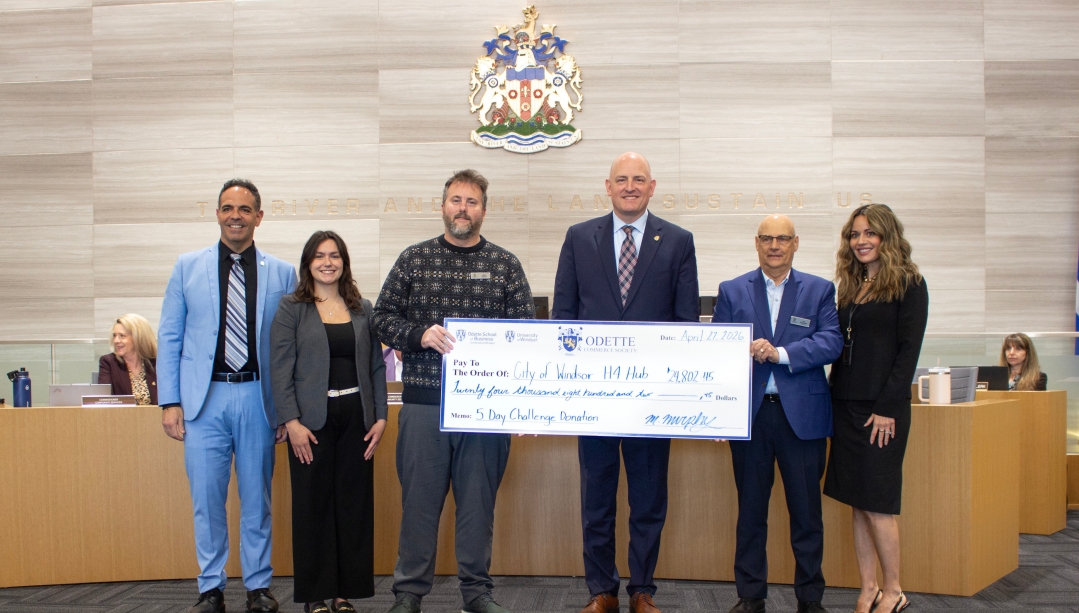 photo of members of City Hall, Odette School of Business and the Farrow Family Foundation holding the donated cheque